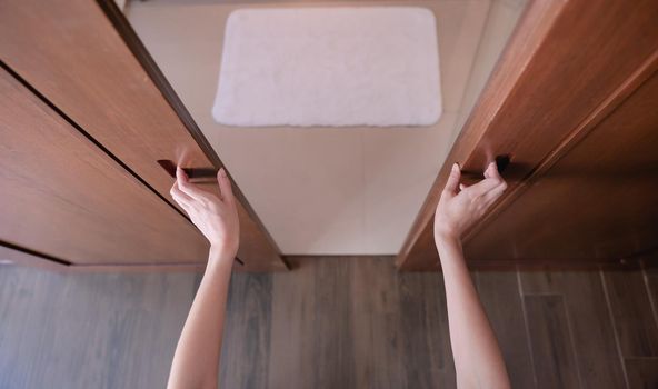 Close up women hand open the door knob or push the wooden door.