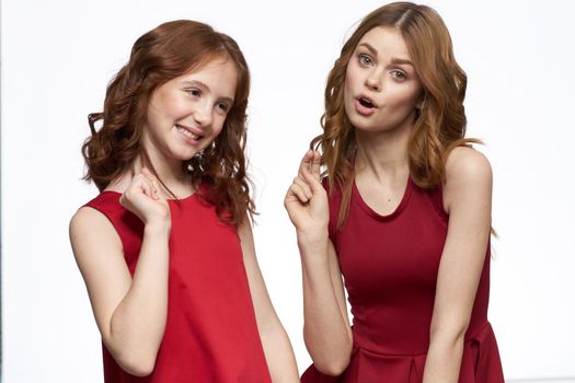 Joyful family fun mom daughter emotions light background. High quality photo