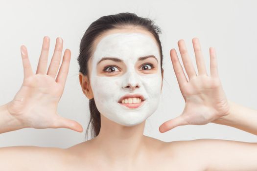 perky brunette naked shoulders cream facial mask skin care treatments. High quality photo