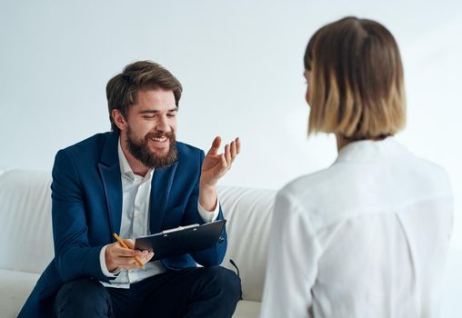 Man and woman sitting on the couch teamwork communication office. High quality photo