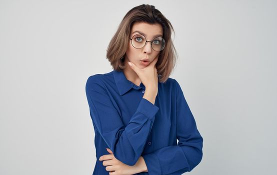 Business woman in a blue shirt and glasses emotions manager classic style. High quality photo
