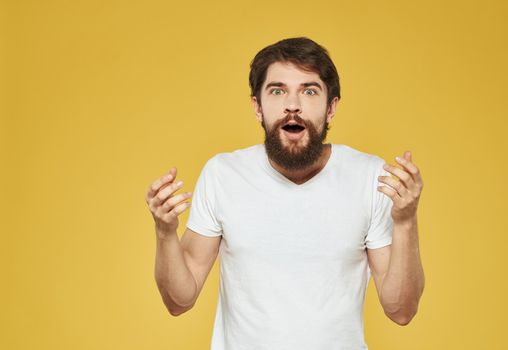 Yellow background model white t-shirt close-up brunette mustache beard. High quality photo