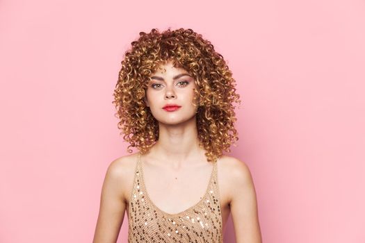 Beautiful woman Curly hair red lips attractive look cropped look bright makeup pink background