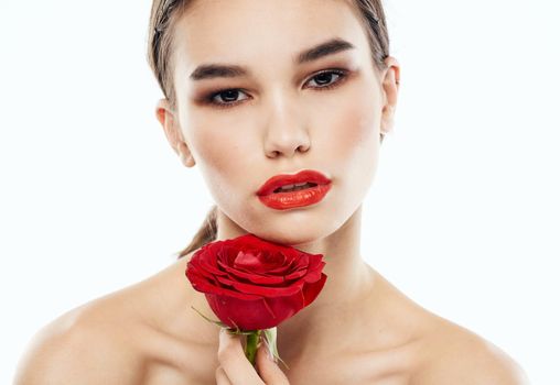romantic woman with friends on eyelids and red flower bare shoulders. High quality photo