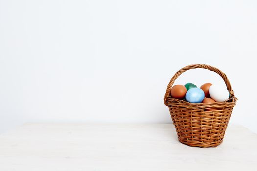 easter eggs in a basket on a light background coffee space holidays gifts. High quality photo