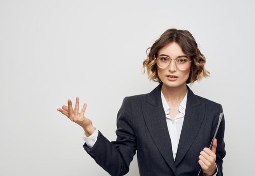 Woman in classic suit shows business financial documents and Copy Space with her hand. High quality photo