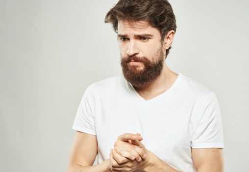 Man in t-shirt cropped view model sad face emotions. High quality photo