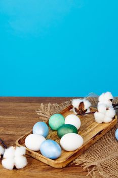 colorful eggs on wooden board celebration christian money decoration. High quality photo