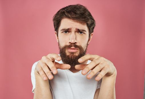 bearded man showing thumb to the side on pink background cropped view Copy Space. High quality photo