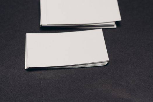 business cards on a dark table and a cup of coffee in the office work finance. High quality photo