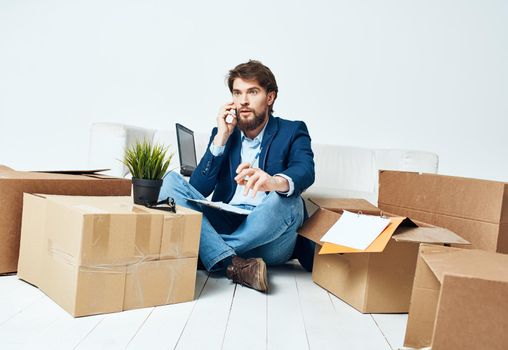 business man talking on the phone boxes with things work office. High quality photo