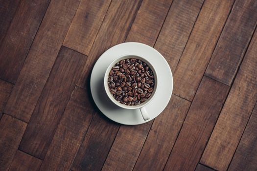 white cup with coffee beans aromatic drink morning energy. High quality photo
