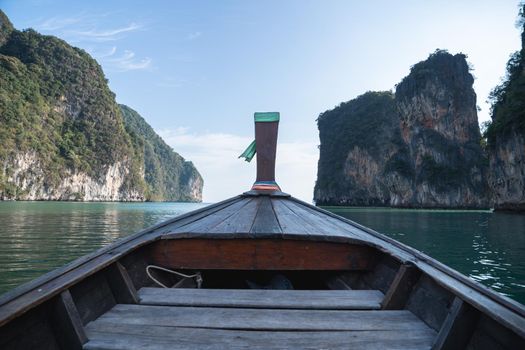 Head of wooden long tailed boat tour heading to beautiful Islands. Thailand Journey boat trip concept.