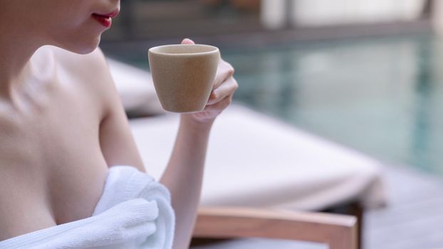 Close up of woman sexy breasts drinking with cup of coffee. Morning coffee.