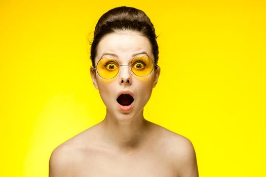 woman with bare shoulders wearing fashion glasses gathered hair. High quality photo