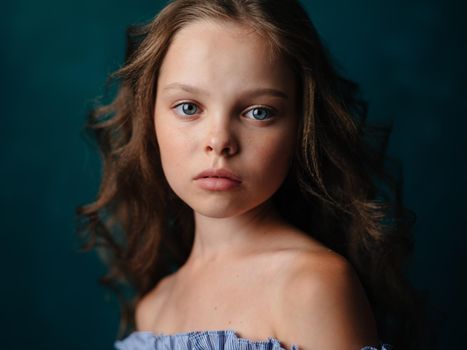 Portrait of a beautiful girl with curly hair hairstyle model bared shoulders. High quality photo