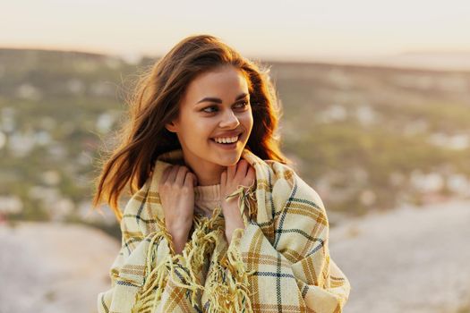 woman with warm summer on her shoulders and nature in the background. High quality photo