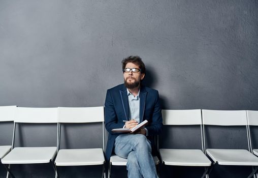 Man sitting on a chair waiting for job interview work lifestyle emotions. High quality photo