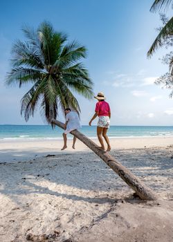 couple on vacation in Thailand, Chumpon province, white tropical beach with palm trees, Wua Laen beach Chumphon area Thailand, palm tree hanging over the beach with a couple on vacation in Thailand.