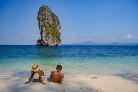 Koh Poda Island Thailand, couple mid age Asian woman and European man on the beach, Koh Poda Thailand, beautiful tropical beach of Koh Poda, Poda Island in Krabi province of Thailand South East Asian