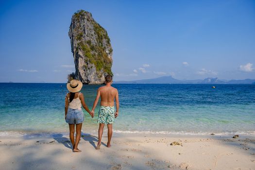 Koh Poda Island Thailand, couple mid age Asian woman and European man on the beach, Koh Poda Thailand, beautiful tropical beach of Koh Poda, Poda Island in Krabi province of Thailand South East Asian