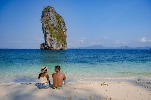 Koh Poda Island Thailand, couple mid age Asian woman and European man on the beach, Koh Poda Thailand, beautiful tropical beach of Koh Poda, Poda Island in Krabi province of Thailand South East Asian