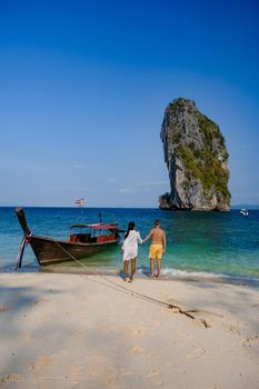 Koh Poda Island Thailand, couple mid age Asian woman and European man on the beach, Koh Poda Thailand, beautiful tropical beach of Koh Poda, Poda Island in Krabi province of Thailand South East Asian