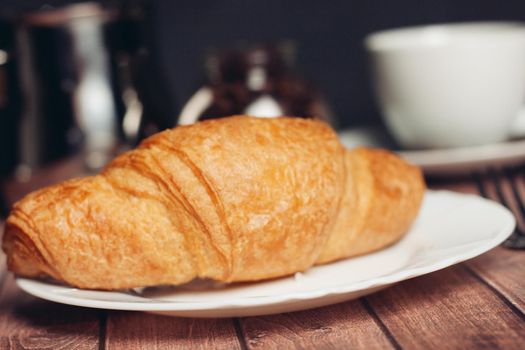 croissants in a plate a cup with a drink a meal dessert snack. High quality photo