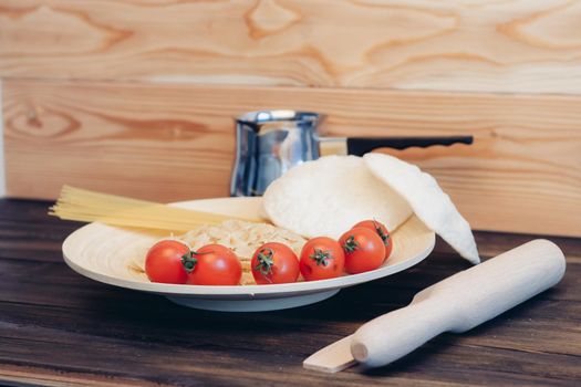 cherry tomatoes pasta kitchenware wooden table italian cuisine. High quality photo