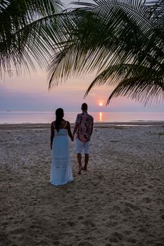 sunrise on the beach with palm trees, Chumphon Thailand, couple watching sunset on the beach in Thailand Asia, mean and woman mid age watching sunrise on beach