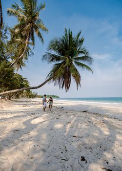 couple on vacation in Thailand, Chumpon province, white tropical beach with palm trees, Wua Laen beach Chumphon area Thailand, palm tree hanging over the beach with a couple on vacation in Thailand.