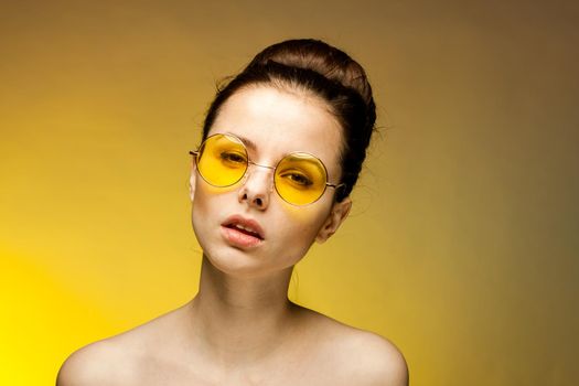 pretty woman naked shoulders yellow glasses fashion emotions charm. High quality photo