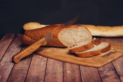 sliced fresh loaf on a wooden cutting board kitchen. High quality photo