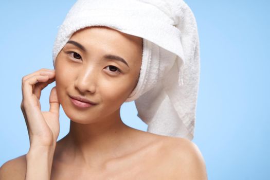 asian woman naked shoulders towel on head spa treatments close-up. High quality photo