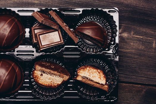 cakes sweets sweets and chocolate cubes on a wooden table. High quality photo
