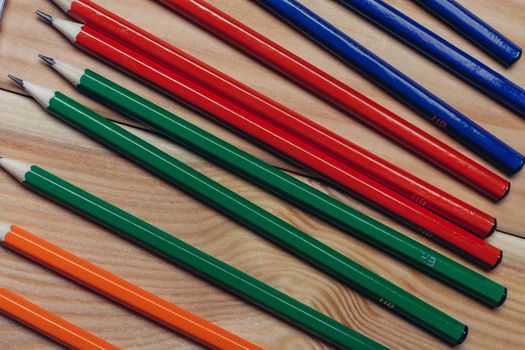 multicolored pencils object on work table wooden background office close-up. High quality photo