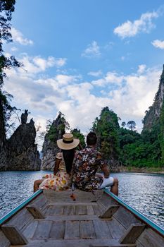 couple on longtail boat visiting Khao Sok national park in Phangnga Thailand, Khao Sok National Park with longtail boat for travelers, Cheow Lan lake, Ratchaphapha dam. man and woman mid age vacation 