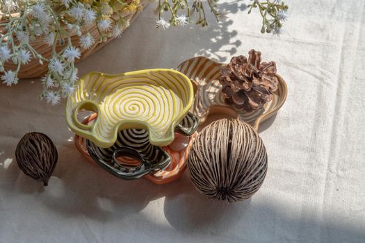 Set of Elephants shaped ceramics cup and Dried cerbera oddloam's seed, Pine cone to Decorate the house beautifully. Elephants shaped cup for dipping sauce, Selective focus.