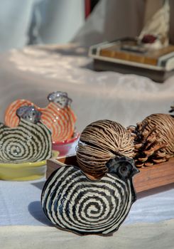 Set of Chickens shaped ceramics cup and Dried cerbera oddloam's seed to Decorate the house beautifully. Chickens shaped cup for dipping sauce, Selective focus.