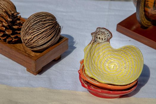 Set of Chickens shaped ceramics cup and Dried cerbera oddloam's seed to Decorate the house beautifully. Chickens shaped cup for dipping sauce, Selective focus.