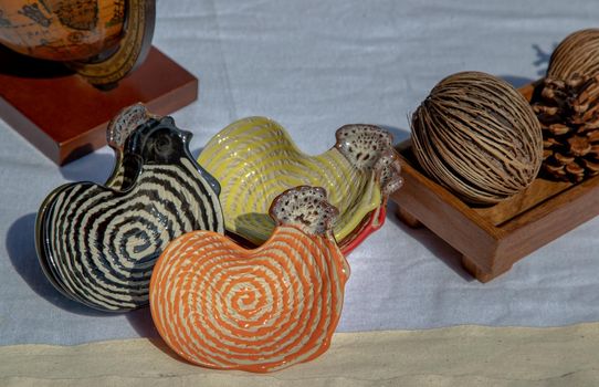 Set of Chickens shaped ceramics cup and Dried cerbera oddloam's seed to Decorate the house beautifully. Chickens shaped cup for dipping sauce, Selective focus.