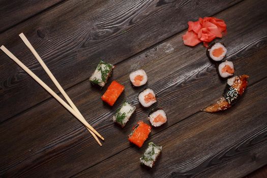 sushi chopsticks rolls snack delicacy japanese cuisine gourmet. High quality photo