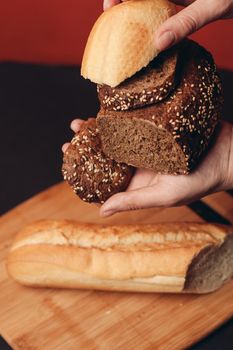 flour products in female hands and sliced baguette on a board. High quality photo