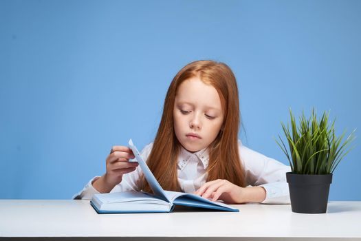 schoolgirl doing homework at the table education learning. High quality photo