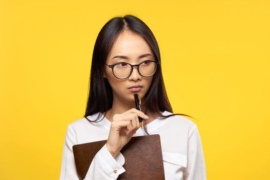 woman asian appearance secretary work office yellow background. High quality photo