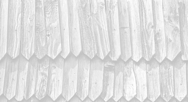Fragment of the wall of an old rural house made of wooden planks. Background texture of old wooden wall. Image in light gray tonality