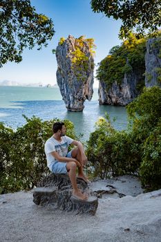 James Bond island near Phuket in Thailand. Famous landmark and famous travel destination, men mid age visiting James Bond island in Krabi Thailand. European man