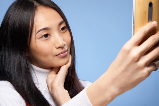pretty brunette with a phone in her hands the charm of internet communication technology close-up. High quality photo