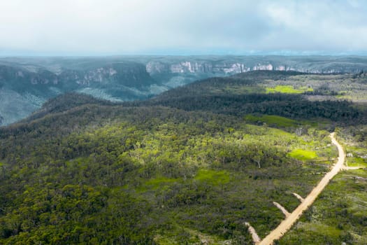 Aerial view of a dirt track running through the Grose Valley near Blackheath in The Blue Mountains in regional New South Wales in Australia