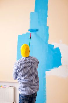 Painter man painting the wall at home